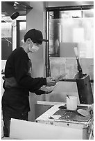 Man preparing tako senbei octopus cracker. Enoshima Island, Japan ( black and white)