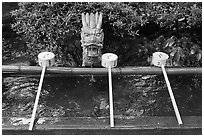 Containers for ritual cleansing. Enoshima Island, Japan ( black and white)