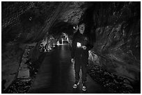 Boy with candle in first Enoshima Iwaya Cave. Enoshima Island, Japan ( black and white)