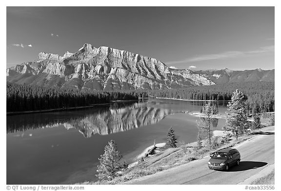 Car on the road besides Two Jack Lake. Banff National Park, Canadian Rockies, Alberta, Canada (black and white)