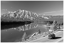 Car on the road besides Two Jack Lake. Banff National Park, Canadian Rockies, Alberta, Canada (black and white)