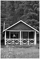 Cabin in the woods with interior lights. Banff National Park, Canadian Rockies, Alberta, Canada (black and white)