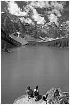 Couple sitting on the edge of Moraine Lake. Banff National Park, Canadian Rockies, Alberta, Canada (black and white)