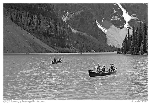 Canoes on the robbin egg blue Moraine Lake, afternoon. Banff National Park, Canadian Rockies, Alberta, Canada (black and white)