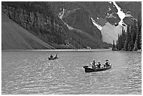 Canoes on the robbin egg blue Moraine Lake, afternoon. Banff National Park, Canadian Rockies, Alberta, Canada (black and white)