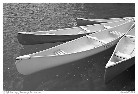 Close up of brightly colored canoes, Moraine Lake. Banff National Park, Canadian Rockies, Alberta, Canada (black and white)