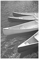 Close up of red, yellow and blue canoes, Moraine Lake. Banff National Park, Canadian Rockies, Alberta, Canada ( black and white)