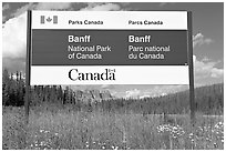 Bilingual sign at the entrance of the Park. Banff National Park, Canadian Rockies, Alberta, Canada ( black and white)