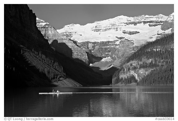 Rower, Lake Louise, and Victoria Peak, early morning. Banff National Park, Canadian Rockies, Alberta, Canada (black and white)