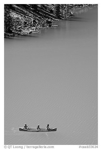 Canoe floatting in Robins egg blue water of Moraine Lake. Banff National Park, Canadian Rockies, Alberta, Canada (black and white)