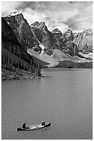 Canoeists below  Wenkchemna Peaks, Moraine Lake, mid-morning. Banff National Park, Canadian Rockies, Alberta, Canada ( black and white)