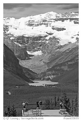 Tourists at observation platform, looking at  Lake Louise and  Victoria Peak. Banff National Park, Canadian Rockies, Alberta, Canada (black and white)