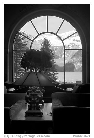 Lake Louise seen through a window of Chateau Lake Louise hotel. Banff National Park, Canadian Rockies, Alberta, Canada (black and white)