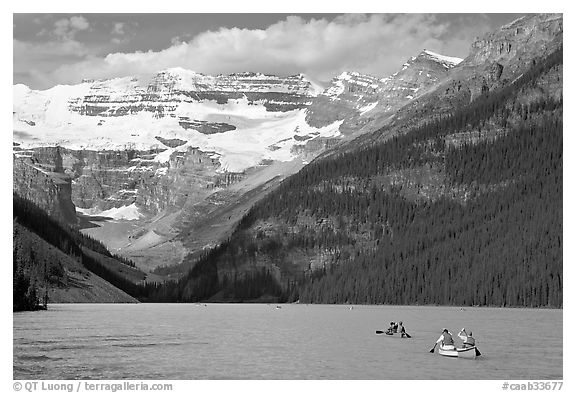 Canoes, Victoria Peak, and blue-green glacially colored Lake Louise, morning. Banff National Park, Canadian Rockies, Alberta, Canada (black and white)
