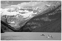 Canoes, Victoria Peak, and blue-green glacially colored Lake Louise, morning. Banff National Park, Canadian Rockies, Alberta, Canada (black and white)