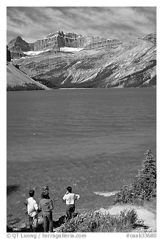 Family standing on the shores of Bow Lake. Banff National Park, Canadian Rockies, Alberta, Canada (black and white)