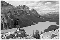 Hiker standing on a rock overlooking Peyto Lake. Banff National Park, Canadian Rockies, Alberta, Canada (black and white)