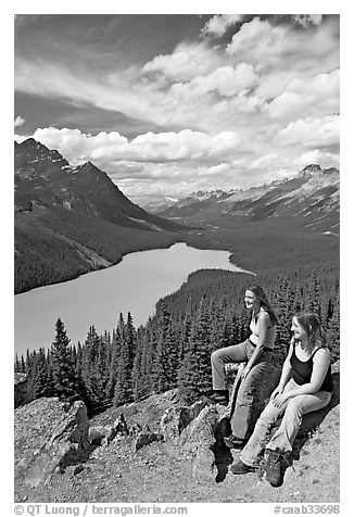 Women sitting on a rook overlooking Peyto Lake. Banff National Park, Canadian Rockies, Alberta, Canada (black and white)