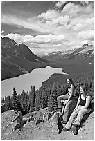 Women sitting on a rook overlooking Peyto Lake. Banff National Park, Canadian Rockies, Alberta, Canada ( black and white)