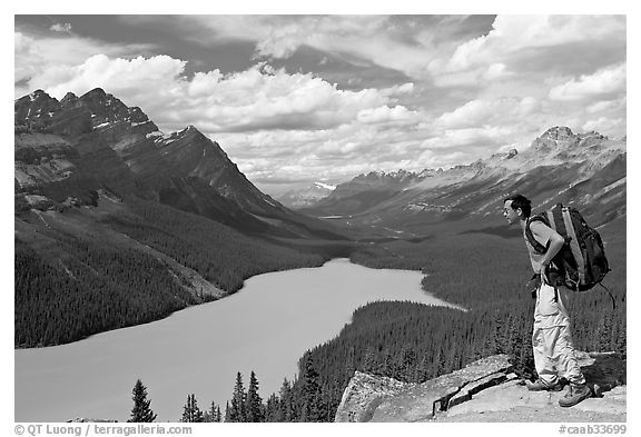 Hiker wearing backpack looking at Peyto Lake. Banff National Park, Canadian Rockies, Alberta, Canada (black and white)