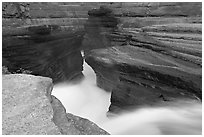 River flowing through narrow rock gorge, Mistaya Canyon. Banff National Park, Canadian Rockies, Alberta, Canada (black and white)