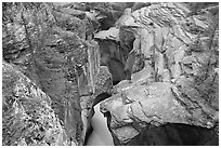 Narrow slot cut in limestone rock by river, Mistaya Canyon. Banff National Park, Canadian Rockies, Alberta, Canada ( black and white)