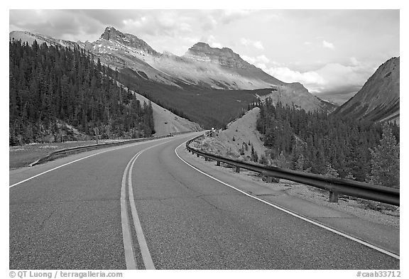 Twisting road, Icefields Parkway, sunset. Banff National Park, Canadian Rockies, Alberta, Canada (black and white)