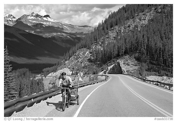 Cyclist with tow, Icefieds Parkway. Jasper National Park, Canadian Rockies, Alberta, Canada