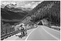 Cyclist with tow, Icefieds Parkway. Jasper National Park, Canadian Rockies, Alberta, Canada (black and white)