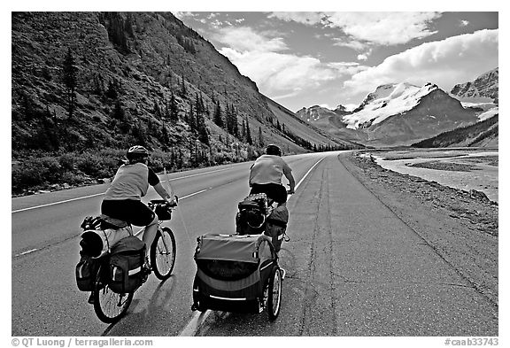 Couple cycling the Icefields Parkway. Jasper National Park, Canadian Rockies, Alberta, Canada (black and white)