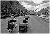 Couple cycling the Icefields Parkway. Jasper National Park, Canadian Rockies, Alberta, Canada (black and white)