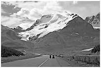 Cyclists on the Icefields Parkway at the base of Mt Athabasca. Jasper National Park, Canadian Rockies, Alberta, Canada (black and white)