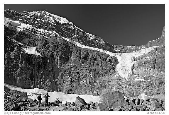 Hikers on a moraine below Mt Edith Cavell, morning. Jasper National Park, Canadian Rockies, Alberta, Canada