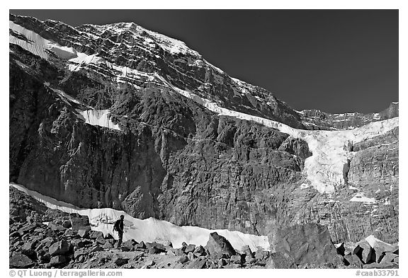 Hiker on a moraine below Mt Edith Cavell and Angel Glacier. Jasper National Park, Canadian Rockies, Alberta, Canada (black and white)