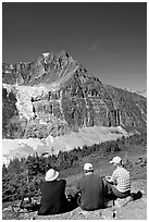 Hikers sitting in front of Mt Edith Cavell next to trail. Jasper National Park, Canadian Rockies, Alberta, Canada ( black and white)