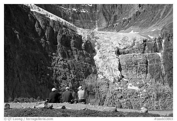 Hikers looking at a hanging glacier on  Mt Edith Cavell. Jasper National Park, Canadian Rockies, Alberta, Canada