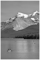 Red canoe on Maligne Lake, afternoon. Jasper National Park, Canadian Rockies, Alberta, Canada ( black and white)