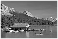 Boat house and canoe beneath Leh and Samson Peaks,  Maligne Lake. Jasper National Park, Canadian Rockies, Alberta, Canada ( black and white)