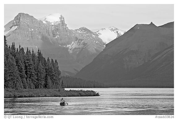 Canoist paddling on Maligne Lake at sunset. Jasper National Park, Canadian Rockies, Alberta, Canada