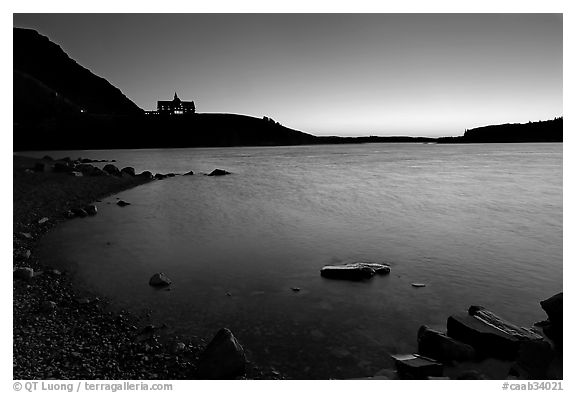 Boulders in Waterton Lake and Prince of Wales hotel, dawn. Waterton Lakes National Park, Alberta, Canada (black and white)
