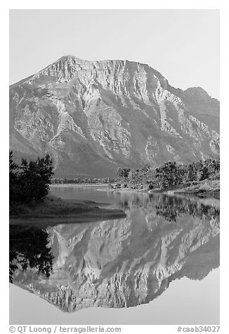 Mountain and reflection in Middle Waterton Lake, sunrise. Waterton Lakes National Park, Alberta, Canada (black and white)