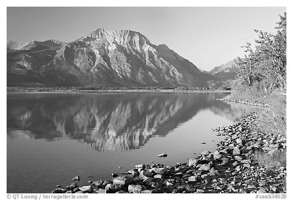 Shoreline with pebbles, Middle Waterton Lake, and Vimy Peak. Waterton Lakes National Park, Alberta, Canada (black and white)