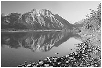 Shoreline with pebbles, Middle Waterton Lake, and Vimy Peak. Waterton Lakes National Park, Alberta, Canada (black and white)