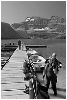 Couple preparing to scuba dive, Cameron Lake. Waterton Lakes National Park, Alberta, Canada (black and white)