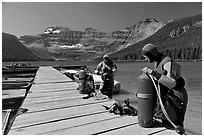 Scuba divers getting ready to dive, Cameron Lake. Waterton Lakes National Park, Alberta, Canada (black and white)