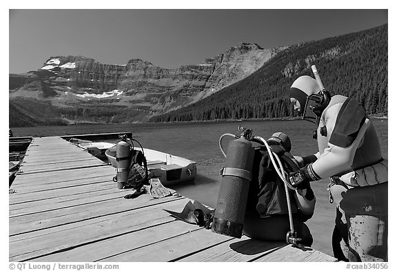 Scuba divers preparing to dive into cold waters of Cameron Lake. Waterton Lakes National Park, Alberta, Canada (black and white)