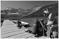 Scuba divers preparing to dive into cold waters of Cameron Lake. Waterton Lakes National Park, Alberta, Canada (black and white)