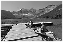 Canoists parking to dock, Cameron Lake. Waterton Lakes National Park, Alberta, Canada (black and white)