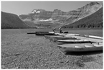 Fishermen walking on dock after unloading a canoe, Cameron Lake. Waterton Lakes National Park, Alberta, Canada ( black and white)