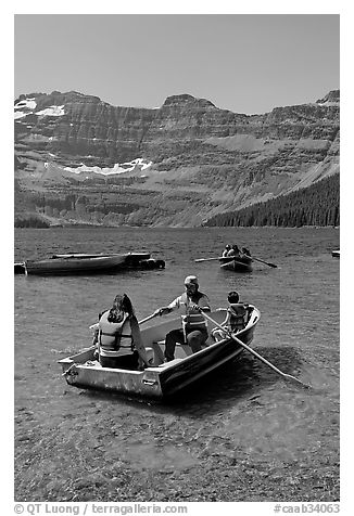 Families boating in Cameron Lake. Waterton Lakes National Park, Alberta, Canada (black and white)